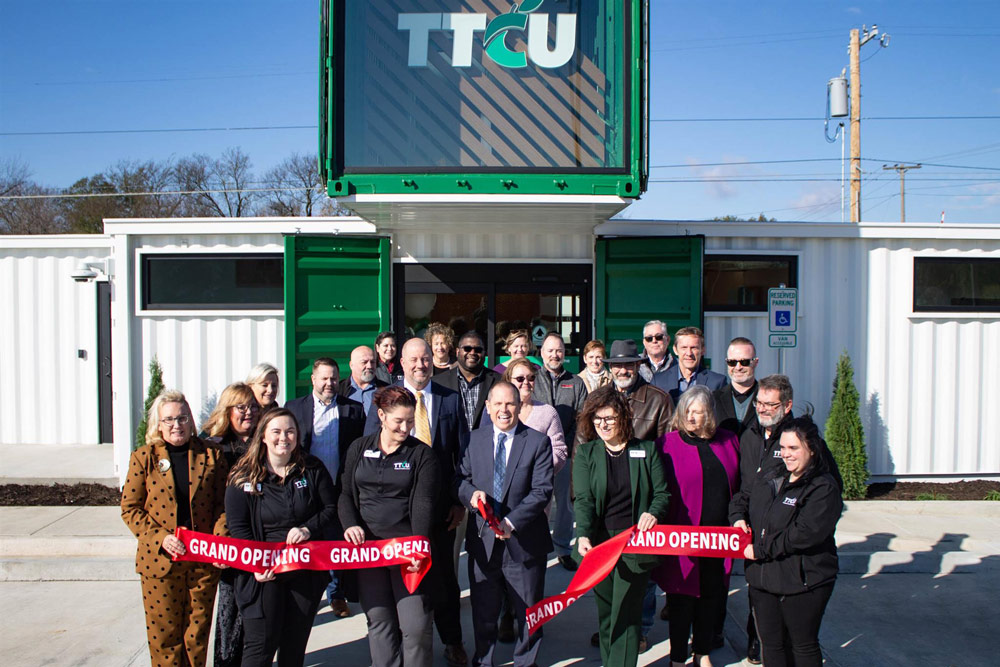 Pryor_Ribbon Group of people cutting a ribbon in front of TTCU Branch